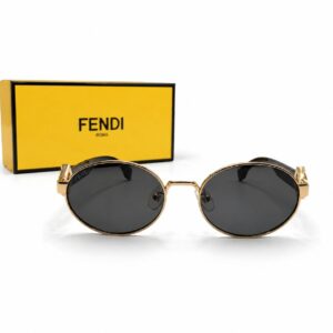 Lunettes de soleil Fendi FF Diamonds de forme ronde en acétate noir et métal doré, présentées devant leur coffret jaune iconique Fendi Roma.